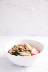 Udon noodles with pork isolated in white background