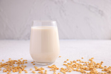 Soy milk in glass and soy bean isolated in white background - 495969483