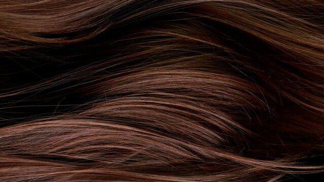 Super slow motion of beautiful healthy long smooth flowing brown hair. Filmed on high speed cinematic camera at 1000 fps.