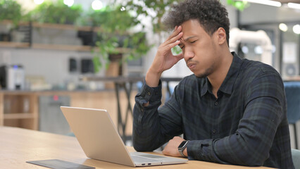 African American Man with Laptop having Headache 