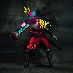 Contemporary art collage. Medieval knight, warrior in balaclava with letterings around playing basketball isolated over black background