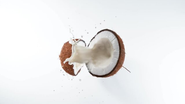 Cracked coconut with splashing milk, super slow motion filmed on high speed cinematic camera at 1000 fps.