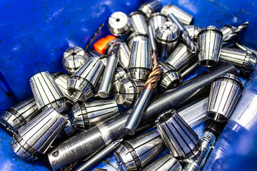 Various types of machine parts are placed together in a blue box. to be replaced with the machine.