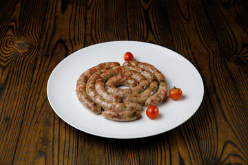 meat products on a white plate on a wooden table
