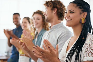 That was a brilliant presentation. Cropped shot of a group of young coworkers applauding with enthusiasm.
