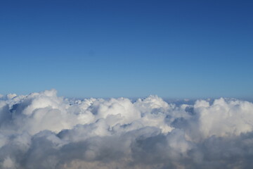 Aerial heaven scene from fluffy white cumulus clouds in the sky for the feeling of freedom 
