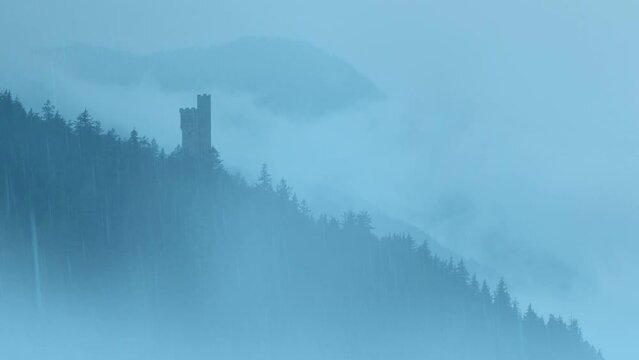 Castle Tower On Mountain In Mist And Rain