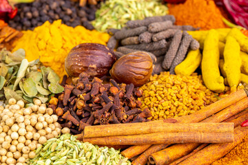Various spices, peppers and herbs close-up top view. Eastern spice market. A set of peppers and spices for cooking.