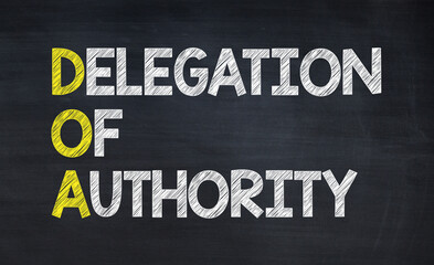 Delegation of authority - DOA acronym written on chalkboard, business acronyms. - obrazy, fototapety, plakaty