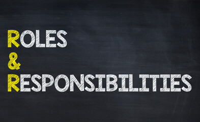 Roles and responsibility - R&R acronym written on chalkboard, business acronyms.