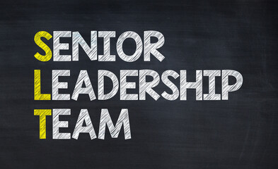 Senior leadership team - SLT acronym written on chalkboard, business acronyms.