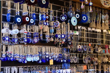 Nazar in East market. Blue and red Fatima eye close-up protective amulet against evil eye. Israeli and turkish souvenir. decorative glass blue souvenirs in the form of an eye 