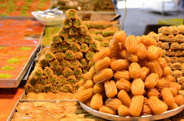 Arabic sweet baked goods. Variety of sweets on the arab street market stall. Eastern sweets in a...