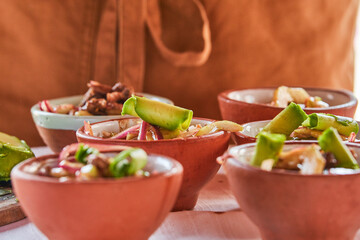 Traditionally made Mexican ceviche. Fish strips with tomato, lettuce, onion, avocado, orange.