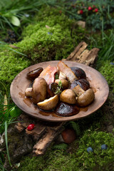 Baked mushrooms with meat in a plate. Photo of food on a dark background