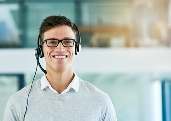 We deliver a five star customer service experience to all. Portrait of a young call center agent working in an office.