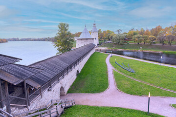 fortress stone wall and watchtowers of the Pskov Kremlin against the background of the river and...