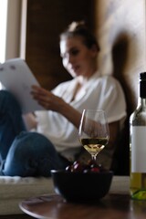 Portrait of young woman with book indoors at home, reading