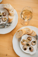 french snail dish with a glass of wine