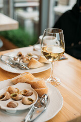 french snail dish with a glass of wine