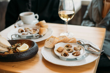 french snail dish with a glass of wine