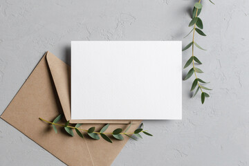 Wedding invitation stationery card mockup with eucalyptus twigs and envelope