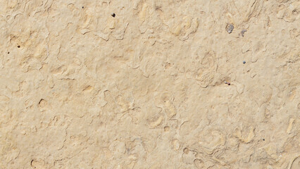 Old marble texture. Beige stone texture with spots and cracks. Cracked vintage wall background