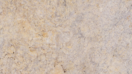 Beige stone texture with spots and cracks. Cracked vintage wall background