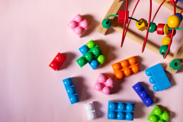 A set of children's educational toys for the development of fine motor skills of the hands. construction set of cubes, maze with wooden beads. concept of education, child development, logic,ingenuity