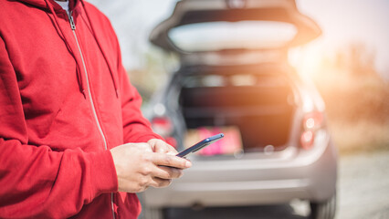 handsome young Hispanic crashed with his car using his cell phone. road safety concept