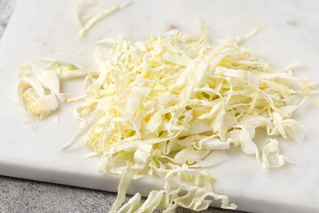Shredded cabbage. Chop cabbage on board. Close up. Macro