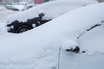 the cars on the parking under snow