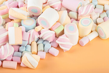 Colorful marshmallows on brown background. Delicious dessert. Fluffy marshmallows.