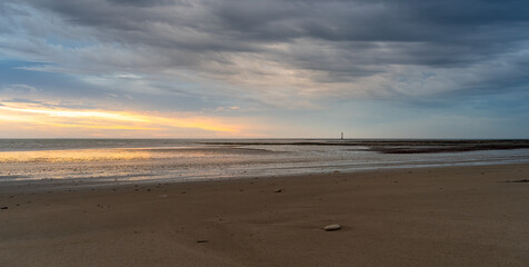 Chauveau Lighthouse standing in atlantic ocean stunning sunset sunrise reflection reflected in water and sea.