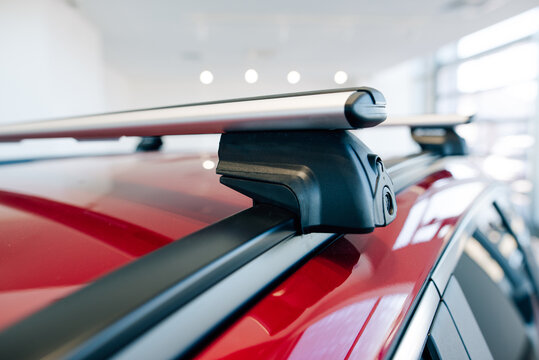 Black roof rail trim on a modern red car
