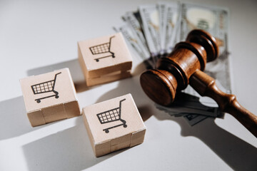 Consumer rights and law concept, judge gavel with dollar banknotes and card boxes on a table
