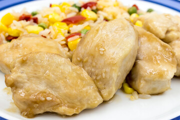Chicken chops with rice and vegetables in a plate closeup