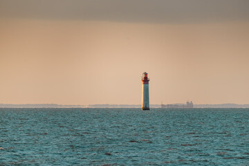 Beautiful minimalist seascape at sunset with Chauveau lighthouse. Rivedoux, Re Island, France