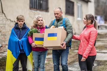 Ukrainian family accepts boxes of humanitarian help after Russia attacked Ukraine creating the...