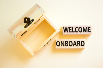 Welcome onboard symbol. Concept words Welcome onboard on wooden blocks on a beautiful white table white background. Empthy wooden chest. Business onboarding and welcome onboard concept, copy space.