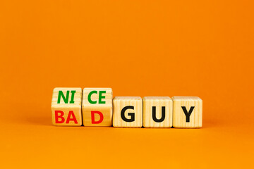 Nice or bad guy symbol. Turned cubes and changed concept words Bad guy to Nice guy. Beautiful orange background. Business psychological nice or bad guy concept. Copy space.