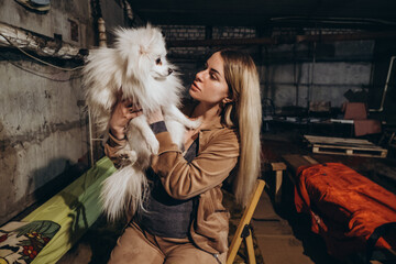 A Ukrainian woman hides in a bomb shelter with a dog, resisting a Russian invasion.