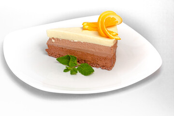 A piece of cake Three chocolates: white, milk and bitter chocolate is on a plate