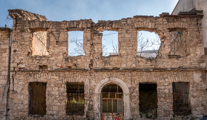 A derelict bomb damaged ruin still remaining from the war in Bosnia on the city of Mostar, Bosnia &...