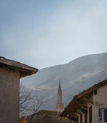 Minaret and mountain in the city of Mostar, Bosnia & Herzegovina