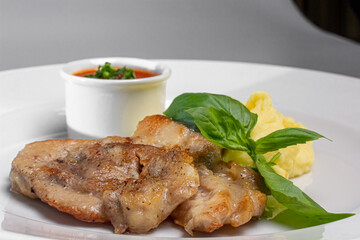 Roast pork with tomato sauce and mashed potatoes