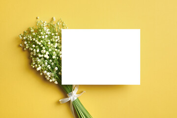 Invitation or greeting card mockup with lily of the valley flowers