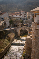 Fototapeta na wymiar The Crooked Bridge over the creek in the city of Mostar, Bosnia & Herzegovina