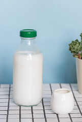 Plant based milk in a glass bottle on the table. Close up