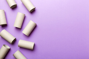 Flat lay composition with empty toilet paper rolls and space for text on color background. Recyclable paper tube with metal plug end made of kraft paper or cardboard